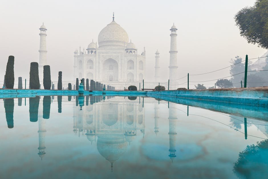 Stunning reflection of the Taj Mahal in Agra, India, captured during a serene morning.